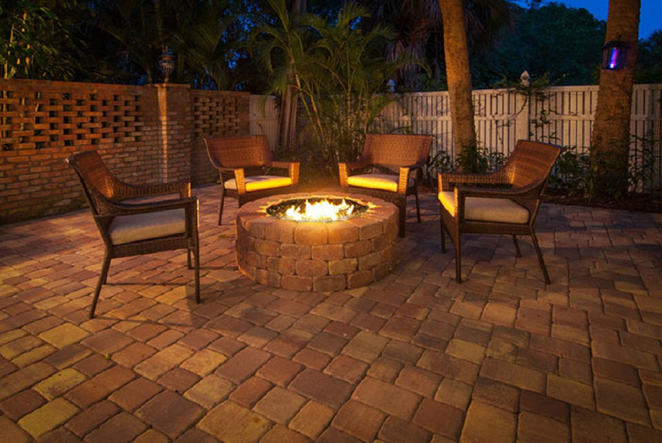 fire pit with chairs around at night