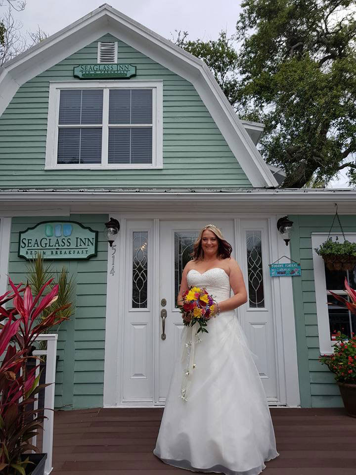 bride standing in front of the SeaGlass Inn Bed and Breakfast